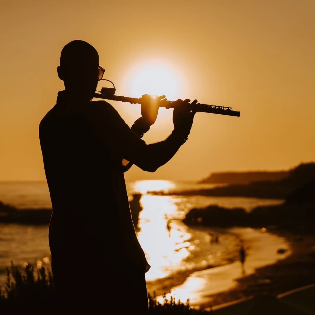 Victor Jazz playing flute at sunset — cocktail hour Cyprus wedding